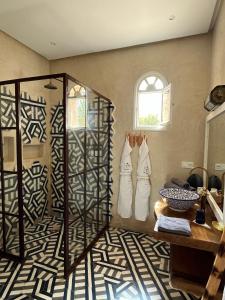 a bathroom with a shower and two pairs of shoes at Riad SABIDI in Essaouira +120 photos