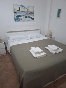 a bedroom with a bed with towels on it at Casa Giulia in Monopoli