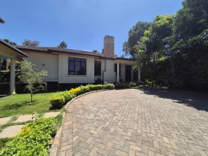a house with a brick driveway in front of it at The Urban EcoLuxe Karen, Nairobi in Nairobi