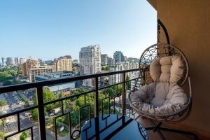 a balcony with chairs and a view of a city at Rodos ArCadia Apartments in Odesa