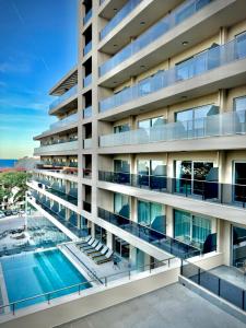 an image of a building with a swimming pool at Poseidon Beach Resort - Premium All Inclusive & Free Riviera Beach Access in Golden Sands +141 photos