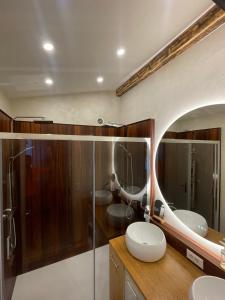 une salle de bain avec deux lavabos et un miroir dans l'établissement Appartement en plein centre du village (6-8 personnes), aux Contamines-Montjoie