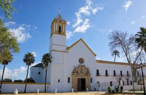 a large white church with a clock tower on it at Apartamento La Carmela in Utrera