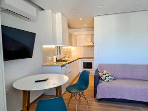 a small living room with a table and a couch at Athens Pearl in Athens