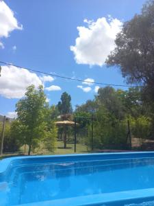 a swimming pool in front of a gazebo at Finca Don Juan Piedra Alta in Junín