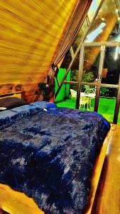 a bedroom with a bed and a table and a window at Soulter glamps in Dargai
