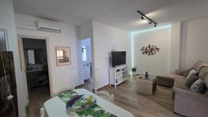 a living room with a couch and a tv at Apartment with terrace in Vecindario +17 photos