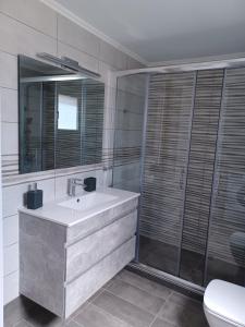 a bathroom with a sink and a shower at Villa Emmelia in Stavros +17 photos