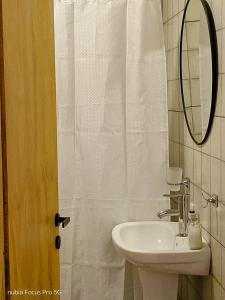 a bathroom with a sink and a mirror at Los Eucaliptos Chascomús in Chascomús