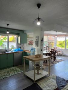 una cocina con armarios verdes y una mesa en Villa with private pool and unique sea view in Çeşme, en Cesme