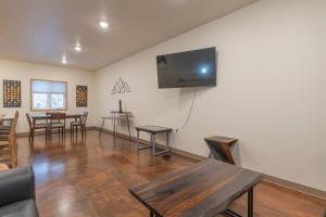 a living room with a table and a flat screen tv at Modern City Suite 2 in Fairbanks