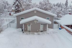 a house with snow on the roof of it at Modern City Suite 2 in Fairbanks