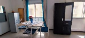 a kitchen with a table with a vase of flowers on it at Coeur urbain in Dakar
