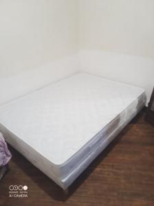 a mattress sitting on top of a wooden floor at Chambre indépendante in Saint-Laurent-de-Neste
