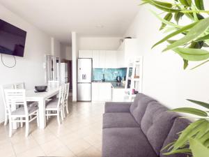 a living room with a couch and a table at LunaSol seaside Apartments in Durrës +27 photos