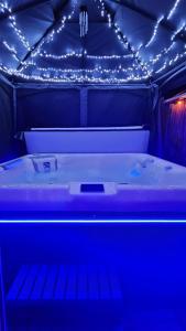 a bed in a room with lights on it at L Escale Spa Privatif in Tournai +52 photos