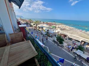 a balcony of a building with a view of a beach at Fronte BLU - FRONTE MARE in Porto Recanati