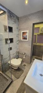 a bathroom with a toilet and a shower and a sink at The Zamalek Residence in Banī Ghālib +21 photos