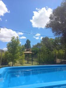 a swimming pool with a gazebo in the background at Finca Don Juan Piedra Alta in Junín