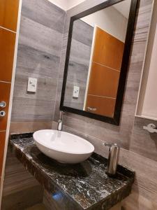 a bathroom with a sink and a mirror at Departamentos Rada in Rada Tilly +11 photos
