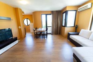 a living room with a couch and a table at GGeorgi Sarafovo in Burgas City