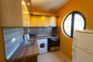 a kitchen with a washer and dryer in it at GGeorgi Sarafovo in Burgas City