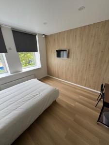 a bedroom with a white bed and a window at 9 New Airport Apartment in VNO