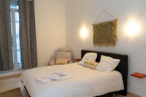 a bedroom with a bed with towels on it at Maison urbaine familiale in Béziers