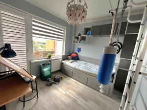 a childs room with a bed and a window at Family Nest in Ventspils