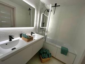 a white bathroom with a sink and a mirror at Family Nest in Ventspils +20 photos