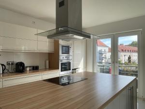 a kitchen with a counter top and a stove top oven at Comfy Apartment in Eichwäldchen