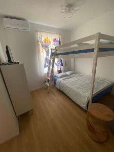 a bedroom with a bunk bed and a ladder at NERi in Koper