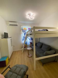 a room with a bunk bed and a couch at NERi in Koper