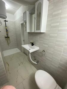 a white bathroom with a sink and a toilet at NERi in Koper +29 photos