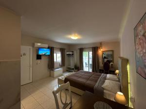 a bedroom with a bed and a living room at Bay View in Faliraki