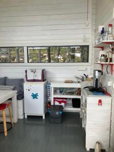 a kitchen with a stove and a refrigerator in a room at Nauvo Valmu in Valmoholm +45 photos
