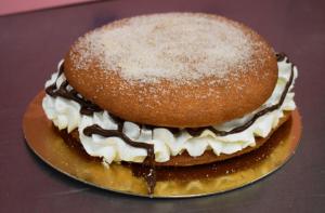 a cake with powdered sugar on top on a plate at Apartamento La Carmela in Utrera