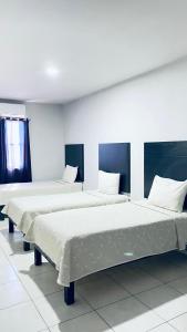 a row of beds in a room at HOTEL TAMPICO EXPRESS MORALILLO in Tampico