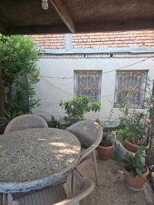 a table and two chairs and a table and some plants at old house in Kutaisi