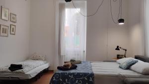 a bedroom with two beds and a window at Casa Maria in Porto Ceresio