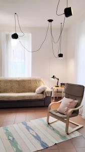 a living room with a chair and a couch at Casa Maria in Porto Ceresio