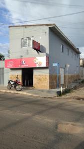 a motorcycle parked in front of a building at Hotel e Restaurante Santa Isabel in São Raimundo Nonato