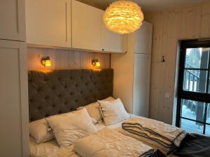 a bedroom with a bed and a chandelier at Fjällbäcken Lindvallen Sälen in Sälen +53 photos