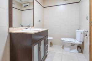 a bathroom with a sink and a toilet at Palmera del mar in Alicante +18 photos