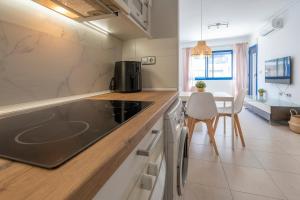 a kitchen with a counter and a dining room at Palmera del mar in Alicante
