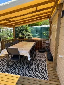 a patio with a table and chairs on a deck at Bungalow in Gassin