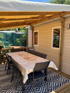 a table and chairs on a patio with awning at Bungalow in Gassin
