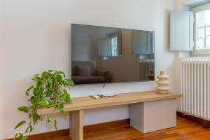 a large mirror on a wall in a living room at Atena at Como Duomo in Como +36 photos
