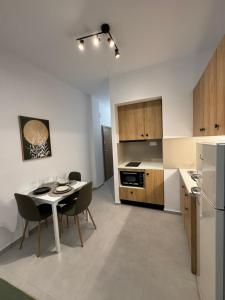 a kitchen with a table and chairs in a room at Creta Apt Mela Β5 in Thérissos