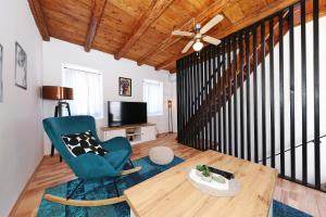a living room with a blue chair and a table at Vacation House Meri in Blato